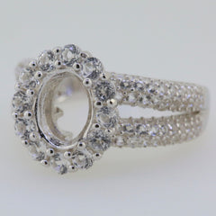 Sterling silver semi mount ring setting with oval halo for 9x7mm gemstones and white topaz accents.